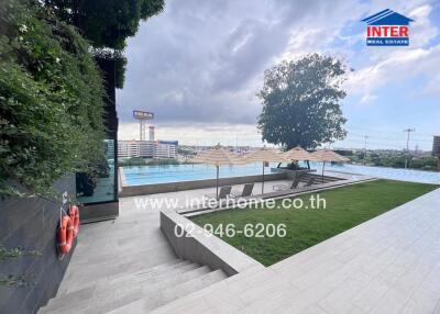 Outdoor swimming pool area with city view