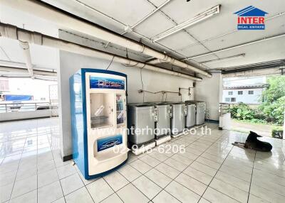 Laundry area with washing machines and water dispenser