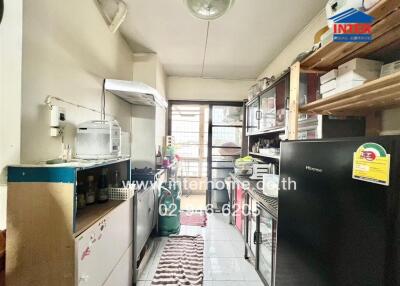 organized kitchen with appliances and storage units