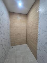 Shower area with beige and white tiles