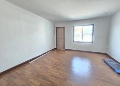 Spacious living room with wooden flooring and large window