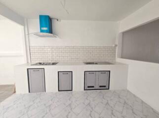 Modern kitchen with white brick backsplash and blue range hood