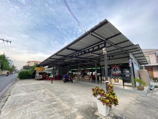 Exterior view of a building with open-air structure and parking area