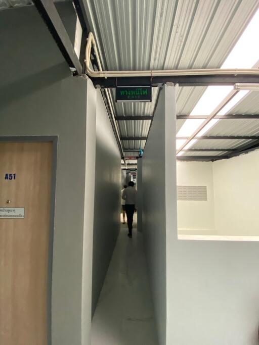 Narrow corridor with industrial ceiling