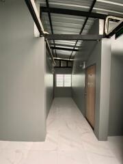 Minimalist hallway with metal ceiling and tiled floor