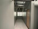 Minimalist hallway with metal ceiling and tiled floor