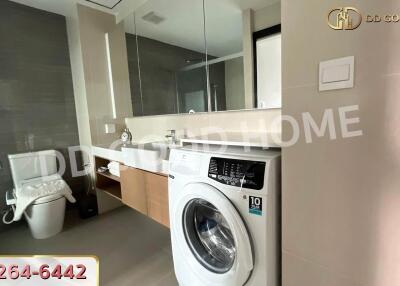 Modern bathroom with washing machine and large mirror