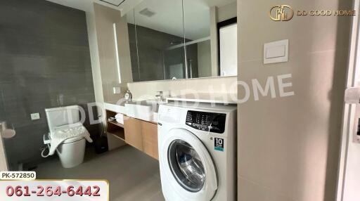 Modern bathroom with washing machine and large mirror