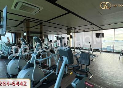 Fitness center with exercise equipment and large windows