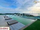 Infinity pool with a scenic view of the coastline and hills