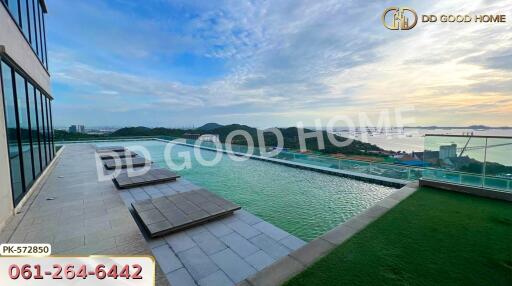 Infinity pool with a scenic view of the coastline and hills