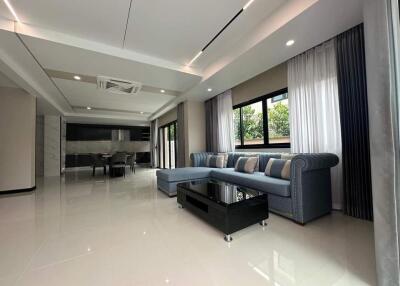 Spacious modern living room with large windows and sectional sofa