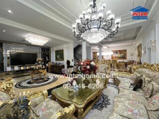 Luxurious living room with ornate furniture and chandeliers