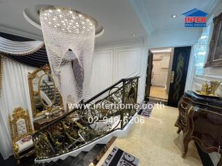 Luxurious foyer with chandelier and ornate decor