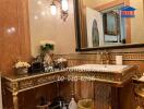 Luxuriously decorated bathroom with ornate fixtures and large mirror