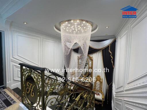 Decorative hallway with chandelier and ornate furnishings