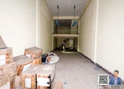 Interior of a building with cardboard boxes and a staircase