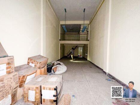 Interior of a building with cardboard boxes and a staircase