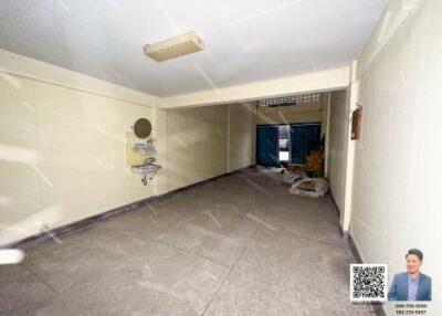 Spacious garage with tiled flooring and a sink