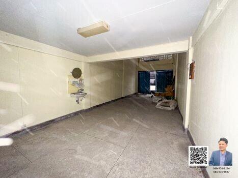 Spacious garage with tiled flooring and a sink