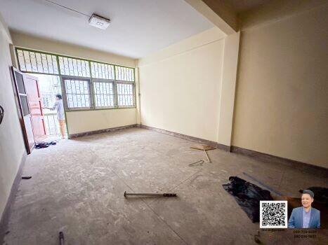 Empty room with large windows and tiled floor