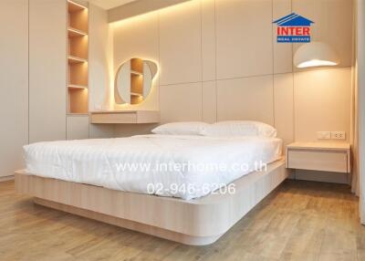 Modern bedroom with bed, decorative lighting, and wooden flooring