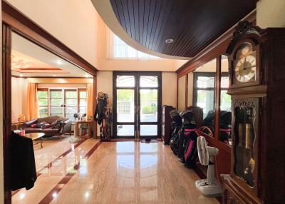 Spacious living area with polished floor and large windows.