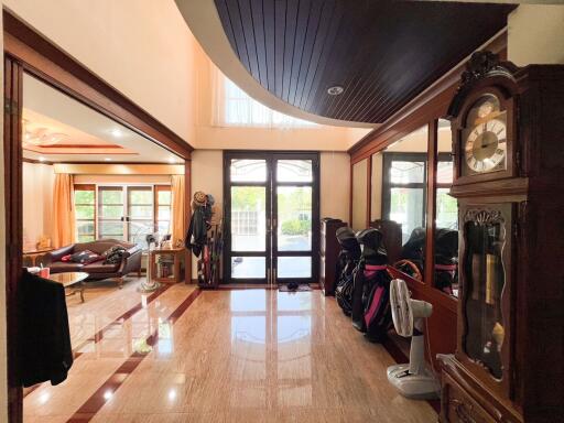 Spacious living area with polished floor and large windows.