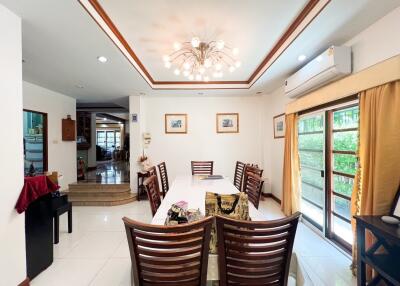 Spacious dining room with modern lighting and large windows