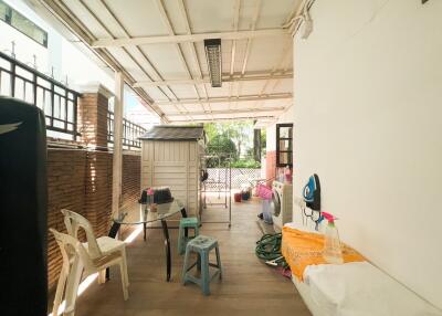 Outdoor covered patio with seating and storage