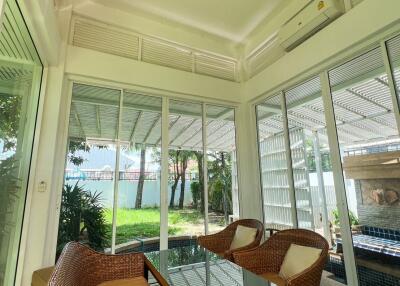 Sunroom with wicker chairs and glass table