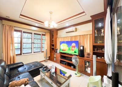 Spacious living room with entertainment center and large windows