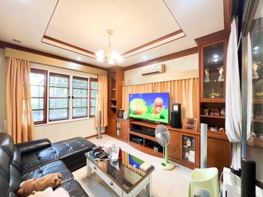 Spacious living room with entertainment center and large windows