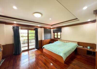 Spacious bedroom with large window and balcony access