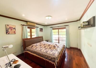 Spacious bedroom with double bed and natural lighting