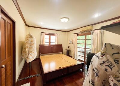 Spacious bedroom with wooden furniture and natural light