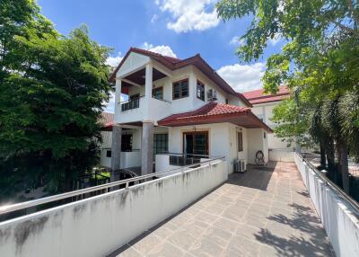 Two-story house with red tile roof and outdoor balcony