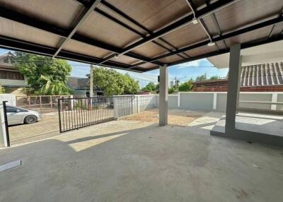 Covered outdoor area with a view of neighboring houses