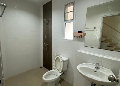 Modern bathroom with shower, toilet, sink and mirror