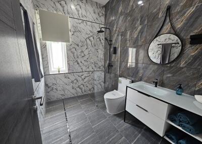 Modern bathroom with marble walls and rainfall shower