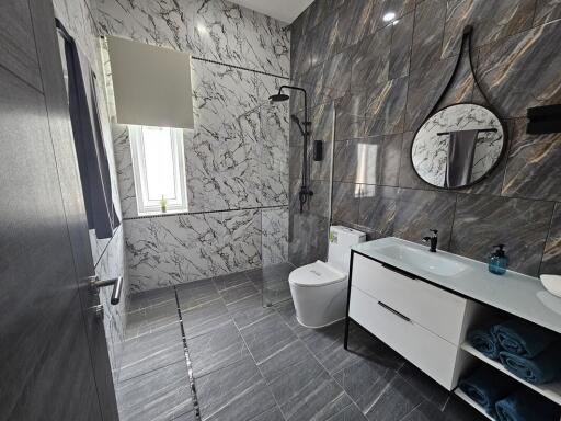 Modern bathroom with marble walls and rainfall shower