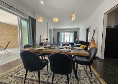 Modern dining area with table setup and view into living room