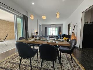 Modern dining area with table setup and view into living room