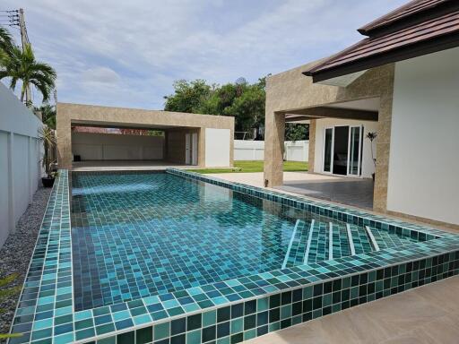 Modern house with a swimming pool and patio area