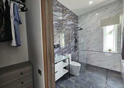 Modern bathroom with walk-in shower and closet