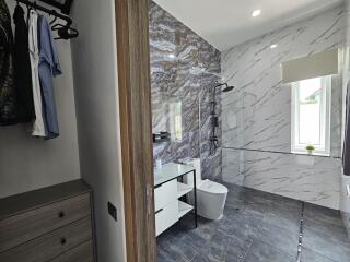 Modern bathroom with walk-in shower and closet