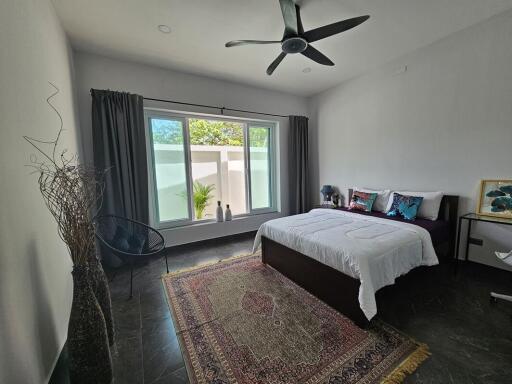 spacious bedroom with large window