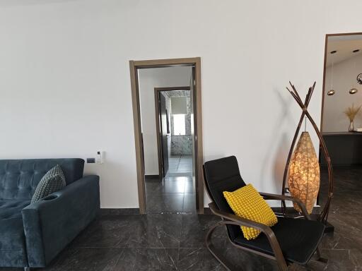 Modern living room with doorway view and decorated with a lamp and a chair