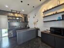 Modern kitchen with dark cabinetry and decorative shelving