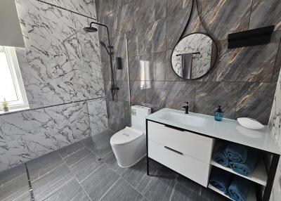 Modern bathroom with marble tiles and glass shower